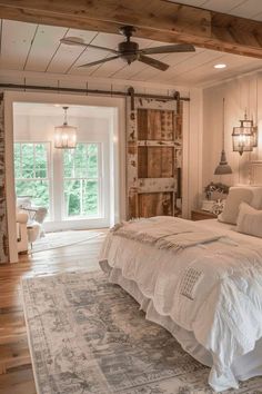 a large bed sitting inside of a bedroom on top of a wooden floor next to a doorway