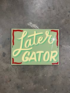 a sticker that says latex gator on the side of a concrete wall