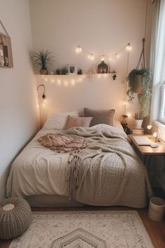 a bed with blankets, pillows and lights in a room