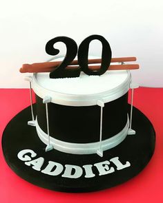 a birthday cake that is shaped like a drum set and has the number twenty on it