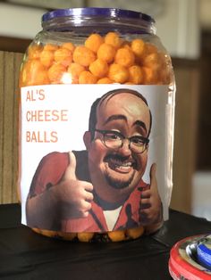 a jar filled with oranges sitting on top of a table next to a magnet