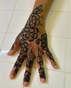 a person's hand with henna tattoos on it