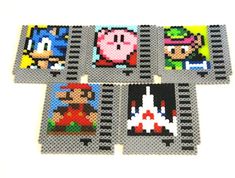 four coasters made out of perler beads with mario and luigi characters on them