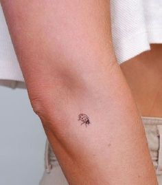 a person with a small tattoo on their arm