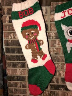 two christmas stockings hanging on a brick wall next to a fire place with an image of a teddy bear and a dog