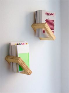 two books are hanging on the wall next to each other, one is upside down