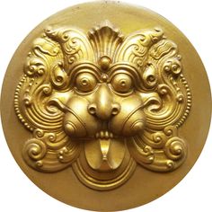 an ornate gold lion head on a white background is seen in this image, it appears to be part of a wall decoration