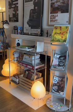 a living room filled with lots of furniture and books on top of a wooden floor