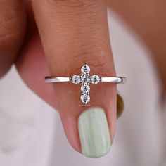 a woman's hand with a diamond ring on it