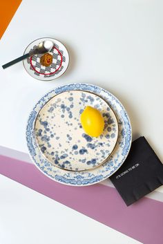 a plate with an egg on it next to a spoon