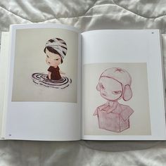 an open book with a drawing of a girl in a bathrobe on the cover