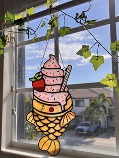 an ice cream sun catcher hanging from a window