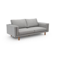 a gray couch sitting on top of a white floor