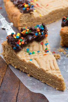 a piece of cookie cake with chocolate frosting and sprinkles on top