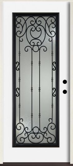 a black iron door with glass on it