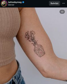 a woman's arm with a flower tattoo on the left side of her arm