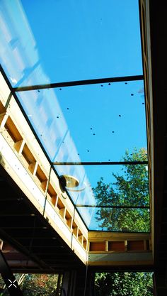 the underside of a building under construction with lots of glass on it's roof