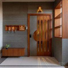 a modern entry way with wooden doors and shelves