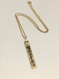 "6mm gold filled Hawaiian pendant with cable chain. The pendant is custom made with a name of your choice. The letters are engraved and enameled. Up to 7 letters can be engraved on the pendant with 1.5\" long . Up to 11 letters can be engraved on the pendant with 1.75\" long. The letters engraved are old english style, typical of Hawaiian heirloom jewelry. The pendant comes with a gold filled cable chain with the length of your choice. All the characters are engraved , not stamped, resulting in Gold Stamped Sterling Silver Charm Necklaces, Gold Sterling Silver Stamped Charm Necklaces, Stamped Gold Charm Necklaces In Sterling Silver, Brass Engraved Initial Pendant Charm Necklace, Personalized 14k Gold Spiritual Charm Necklaces, Personalized 14k Gold Spiritual Charm Necklace, Spiritual 14k Gold Personalized Charm Necklaces, Gold Personalized Spiritual Charm Necklaces, Gold Stamped Pendant Charm Necklace