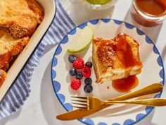 a blue and white plate topped with food next to a pan filled with fruit pie