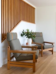 two chairs sitting next to each other on top of a hard wood floor