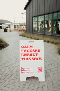 a sign that says calm focused energy this way on the side of a brick walkway