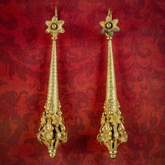 A spectacular pair of antique Georgian night and day earrings from the early 19th Century crafted in pinchbeck and gilded in 18ct yellow gold. The long droppers are chased with a fabulous chevron pattern and lead to ornate, cannetille metalwork at the bottom which is intricately detailed with beautiful floral decoration.   The flower shaped tops are fitted with lever back hooks and are perfect worn on their own as daytime earrings. The long droppers can then be added later for a more glamorous e Antique Gold Earrings With Historical Design, Antique Earrings With Historical Design For Ceremonial Occasions, Antique Drop Earrings With Historical Design, Gold Earrings With Historical Design For Wedding, Ornate Gold Earrings With Historical Design, Gold Earrings With Historical Design For Formal Occasions, Elegant Yellow Gold Earrings With Historical Design, Victorian Style Ceremonial Earrings For Pierced Ears, Formal Drop Earrings With Historical Design