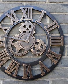 a clock on the side of a brick wall with roman numerals and gears