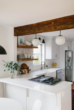 a kitchen with an oven, stove and sink in it's center island next to a window