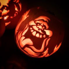 two carved pumpkins with faces on them