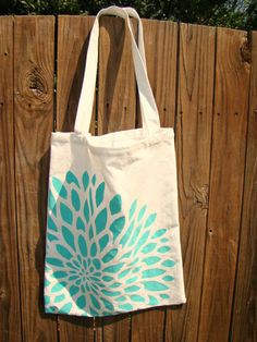 a white and blue bag hanging on a wooden fence