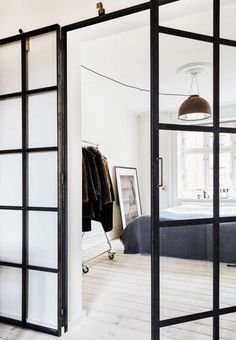 an open glass door leading to a bedroom