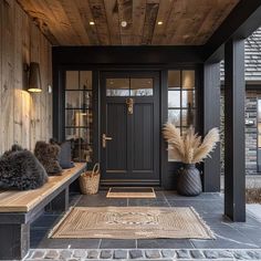 a black front door with two benches on the side