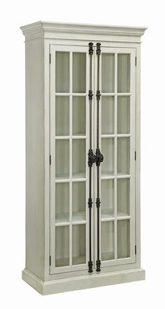 a tall white cabinet with glass doors