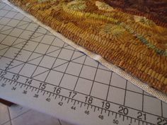 the ruler is next to an area rug