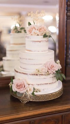 a three tiered wedding cake with pink flowers on top