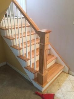 there is a stair case next to the carpet on the floor