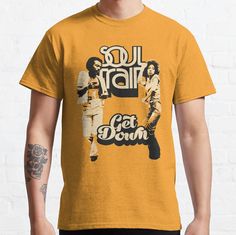 Standard fit with double-needle hems for durability. Solid colors are 100% preshrunk cotton, heather colors are cotton blend. Range of colors available, with the option to print on front or back. Size range S-3XL, suitable for men and women. Get down to the funky sound of Soul Train. Yellow Cotton Fan Apparel T-shirt, Fitted Graphic Print T-shirt In Ring-spun Cotton, Fitted Cotton T-shirt With Graphic Print, Retro Tri-blend Pre-shrunk T-shirt, Retro Tri-blend T-shirt, Casual Ring-spun Cotton T-shirt With Graphic Design, Retro Pre-shrunk Ring-spun Cotton T-shirt, Soul Train, Male Model