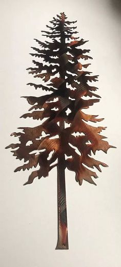 a tall metal pine tree with leaves on it's tip is shown against a white background