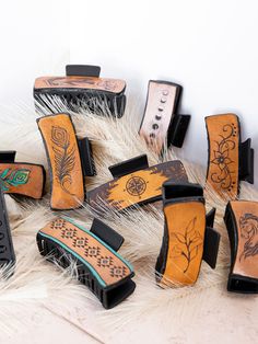 several different types of hair brushes sitting on top of a pile of fur covered floor