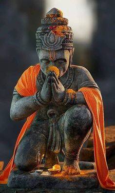 an image of a statue that is sitting on the ground with his hands clasped to his face