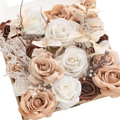 an arrangement of flowers in a box on a white background