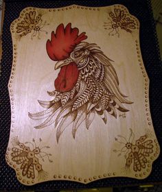 a wooden plaque with a rooster on it