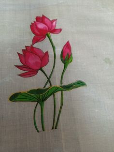 three pink flowers on a white cloth with green stems