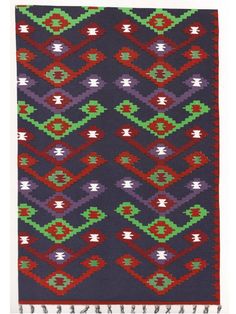 a colorful rug with fringes on the bottom and an intricate design in red, green,