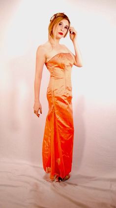 Dress Inn By Ynna's  Y2K Evening Gown Beaded Metallic Irridescent  Strapless Orange  Circa 1990s  *Excellent Condition *Zipped Down Back Bust: 34" Waist: 28" Hips: 38" Shoulders: 15" Length: 49"  I do not accept returns or trades. Please read the description carefully. I am always happy to answer questions prior to your purchase. #nbvavailable Fitted Orange Evening Dress For Prom, Orange Fitted Evening Dress For Formal Events, Fitted Orange Evening Dress For Formal Events, Orange Fitted Formal Evening Dress, Fitted Orange Gown For Prom, Formal Fitted Orange Evening Dress, Fitted Orange Evening Dress For Gala, Fitted Orange Evening Dress, Fitted Orange Gown For Party