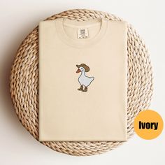 "Embroidered Cowboy Silly Goose Shirt | Silly Goose Shirt | Embroidered Goose Crewneck |  Embroidered Shirt | Silly Goose On The Loose Matching Sweatshirt: https://printworkshopcompany.etsy.com/listing/1564603797/embroidered-silly-cowboy-goose Matching Dad Hat: https://printworkshopcompany.etsy.com/listing/1567277457/cowboy-silly-goose-embroidered-dad-hat ** HOW TO ORDER 1. Check our photos for sizing and color options.  2. Select your size and color from the drop-down menus.  3. Click \"ADD TO CART\" to add the shirt to your cart. 4. Click \"PROCEED TO CHECKOUT\" to purchase your shirt. ** VIP Email List Be sure to join our VIP Email list for new product releases, special promotions, and giveaways! https://email.everbee.io/subscribe?shopName=PrintWorkshopCompany ** PRODUCTION TIME: 1-3 da Casual Cotton Shirt With Machine Embroidery, Casual Cotton Shirt With Motif, Embroidered Beige Cotton Shirt, Beige Embroidered Cotton Shirt, Silly Goose Tattoo, Silly Cowboy, Goose Tattoo, Country Clothing, Silly Goose