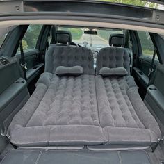 an inflatable mattress is placed on the back of a car's trunk