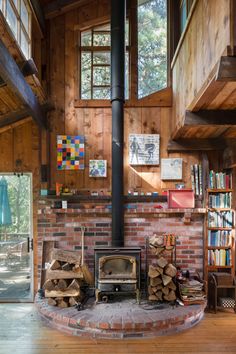 a room with a brick fireplace and lots of wood