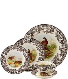 four plates and two cups with birds on them